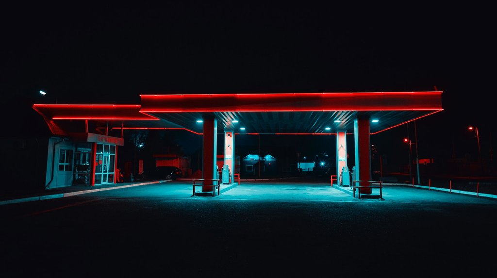 Gasoline station during nighttime with glowing red roof lights